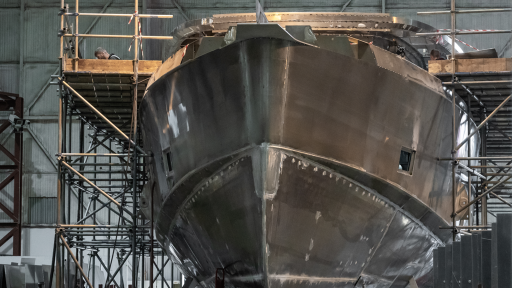 The aluminium components of a ship in a factory setting.